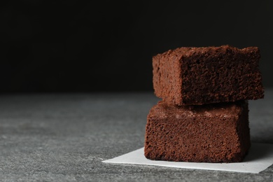 Fresh brownies on table, space for text. Delicious chocolate pie