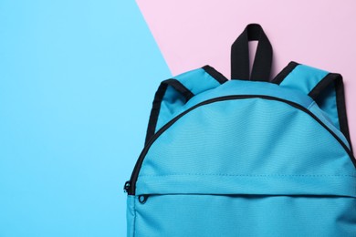 Stylish light blue backpack on color background, top view. Space for text