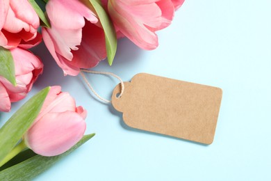 Photo of Happy Mother's Day. Beautiful tulips with blank card on light background, flat lay