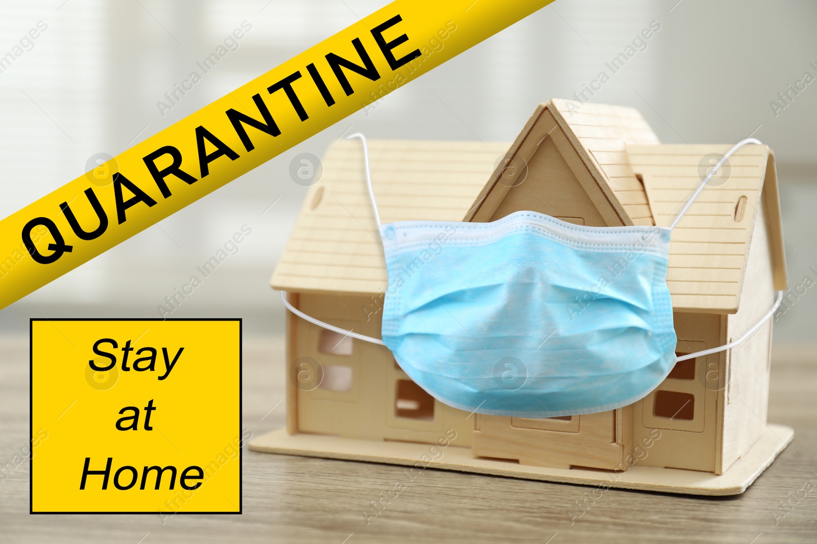 Image of Stay at home during coronavirus quarantine. Wooden house model with medical mask