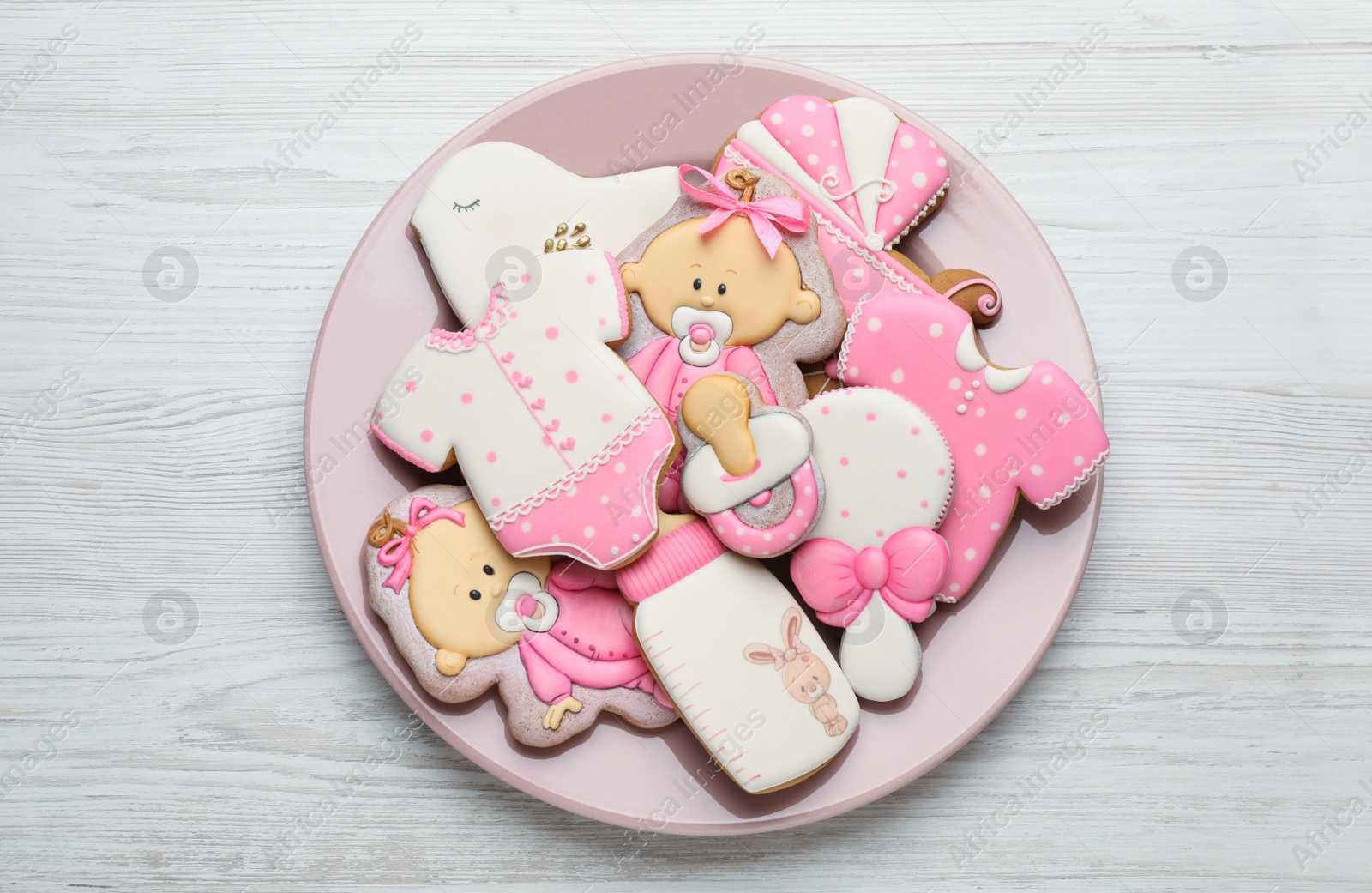 Photo of Cute tasty cookies of different shapes on white wooden table, top view. Baby shower party