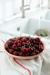 Fresh ripe cherries on countertop in kitchen
