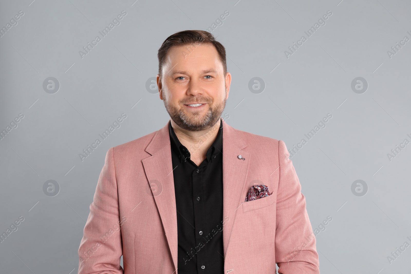 Photo of Portrait of happy mature man on light grey background