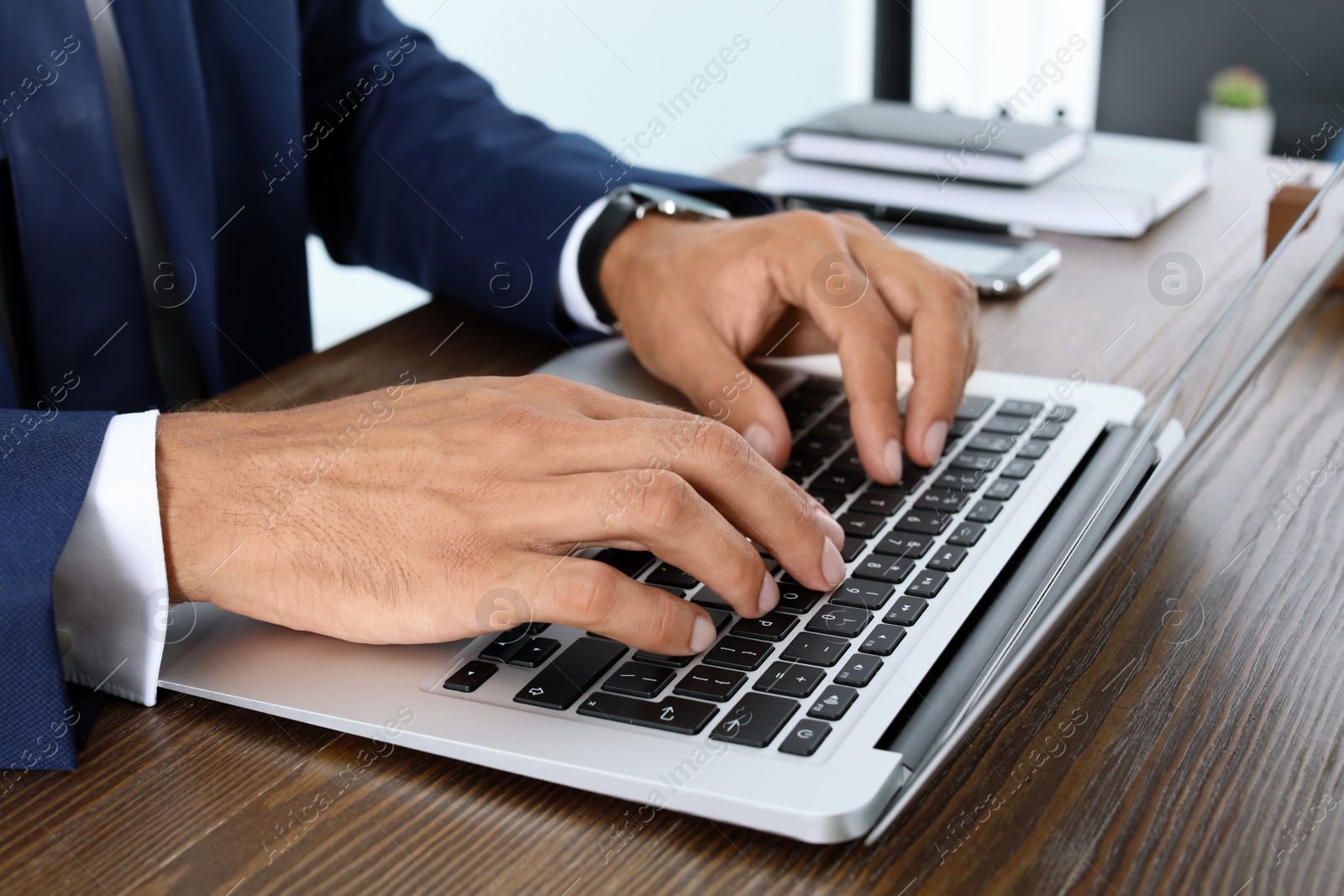 Photo of Lawyer working with laptop at table, closeup