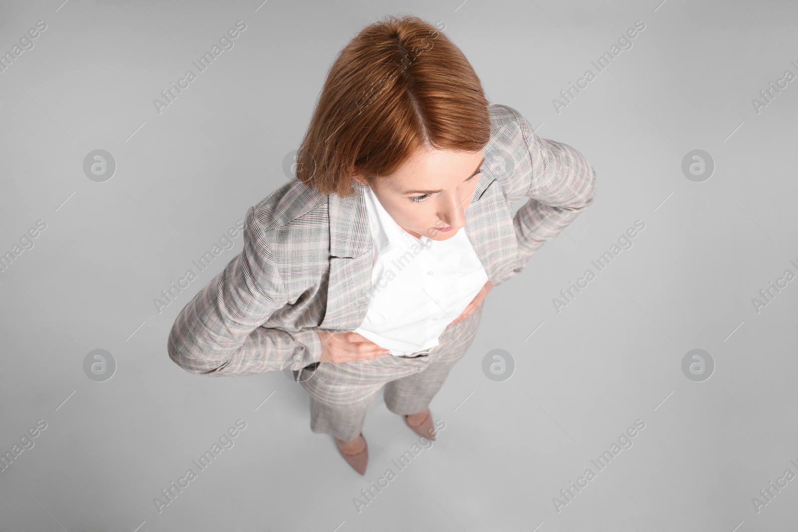 Photo of Young woman on grey background, above view