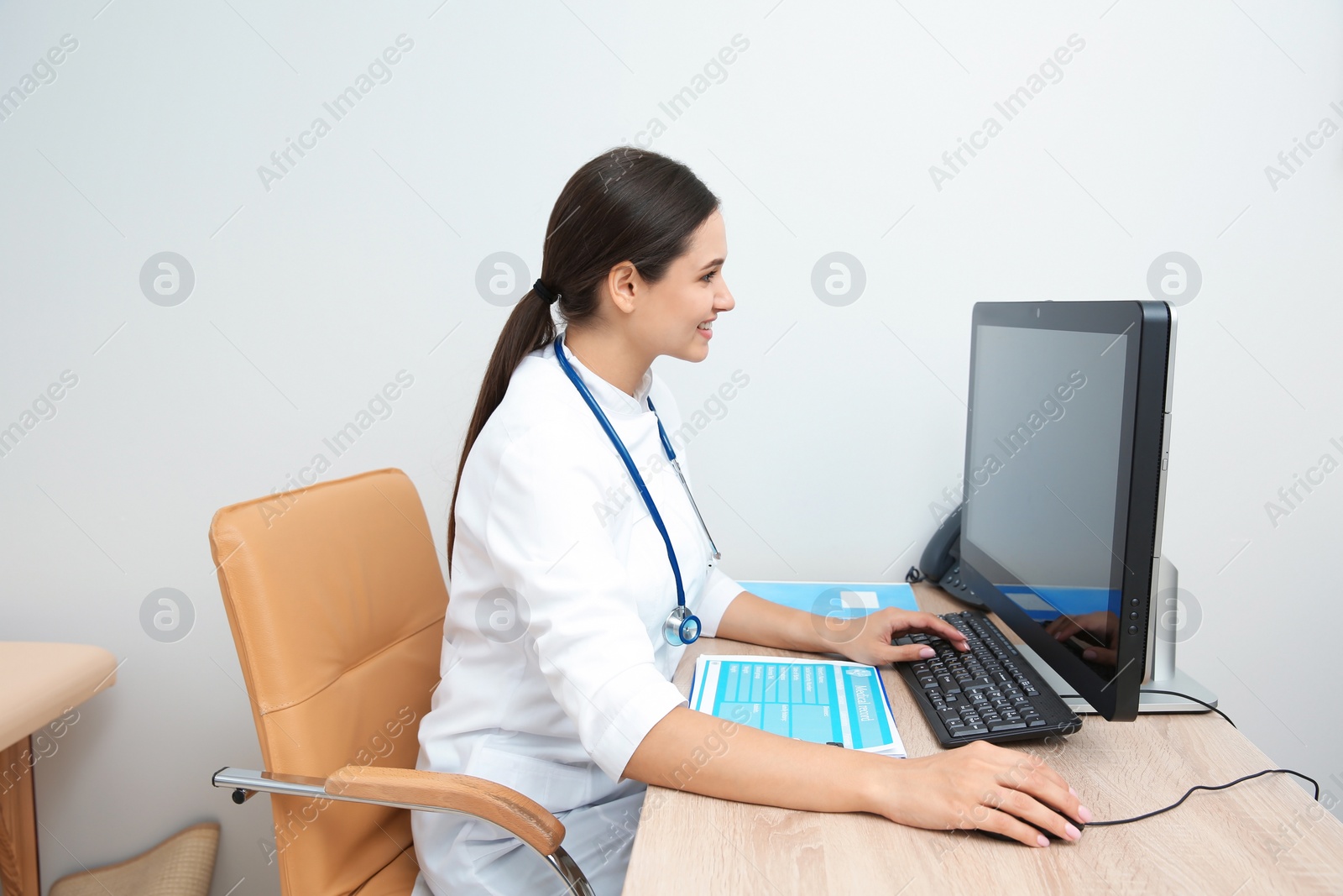 Photo of Portrait of young gynecologist at table in hospital