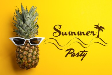 Summer party. Pineapple with sunglasses on yellow background, top view