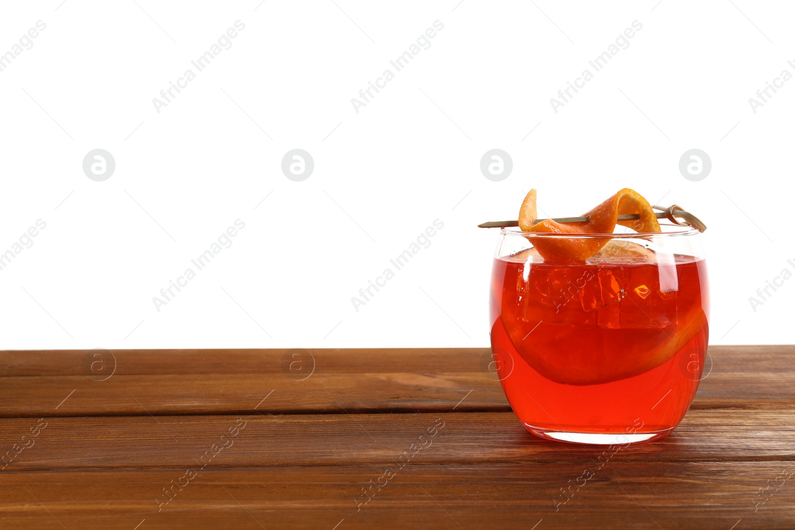 Photo of Aperol spritz cocktail and orange slices in glass on wooden table against white background