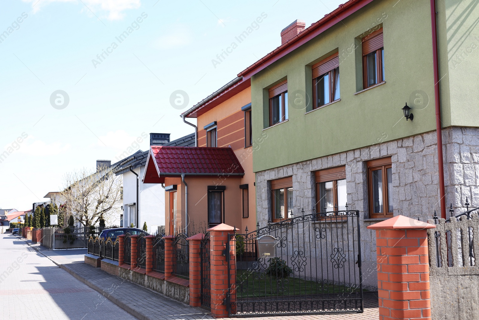 Photo of Suburban street with beautiful buildings on sunny spring day