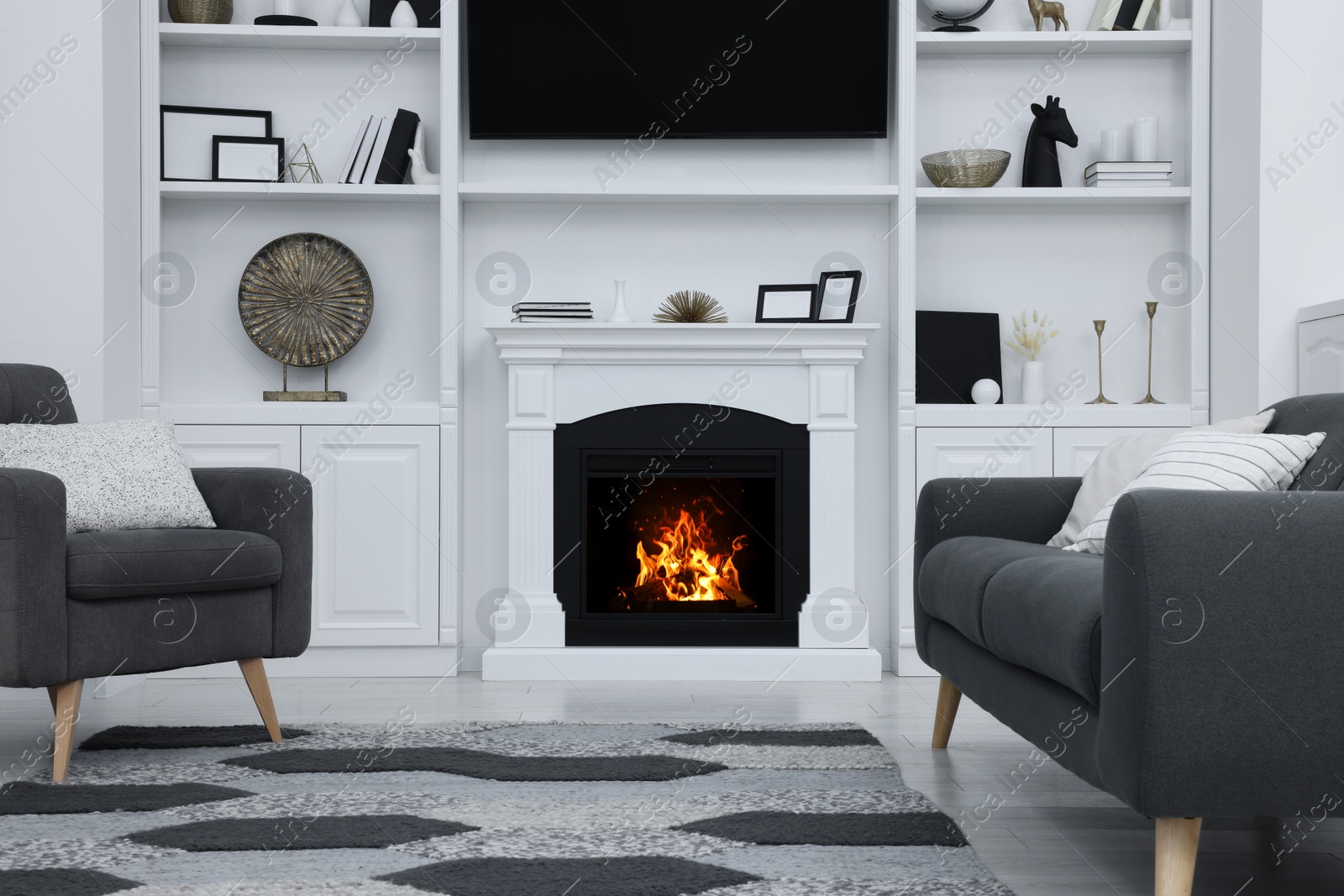 Photo of Stylish room with beautiful fireplace and comfortable furniture. Interior design