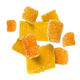 Image of Pieces of honeycomb falling on white background