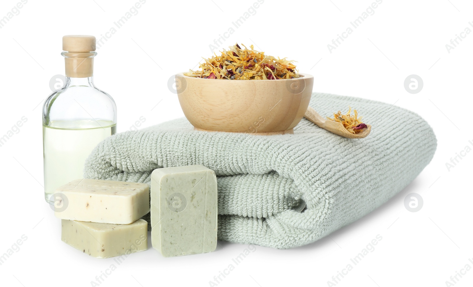 Photo of Spa composition. Towel, essential oil, soap and dry flowers on white background