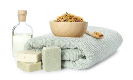 Photo of Spa composition. Towel, essential oil, soap and dry flowers on white background