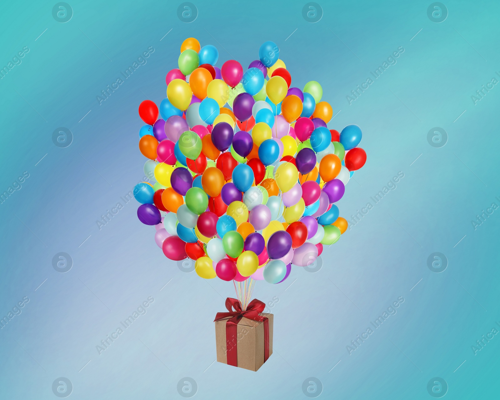Image of Many balloons tied to gift box on bright background