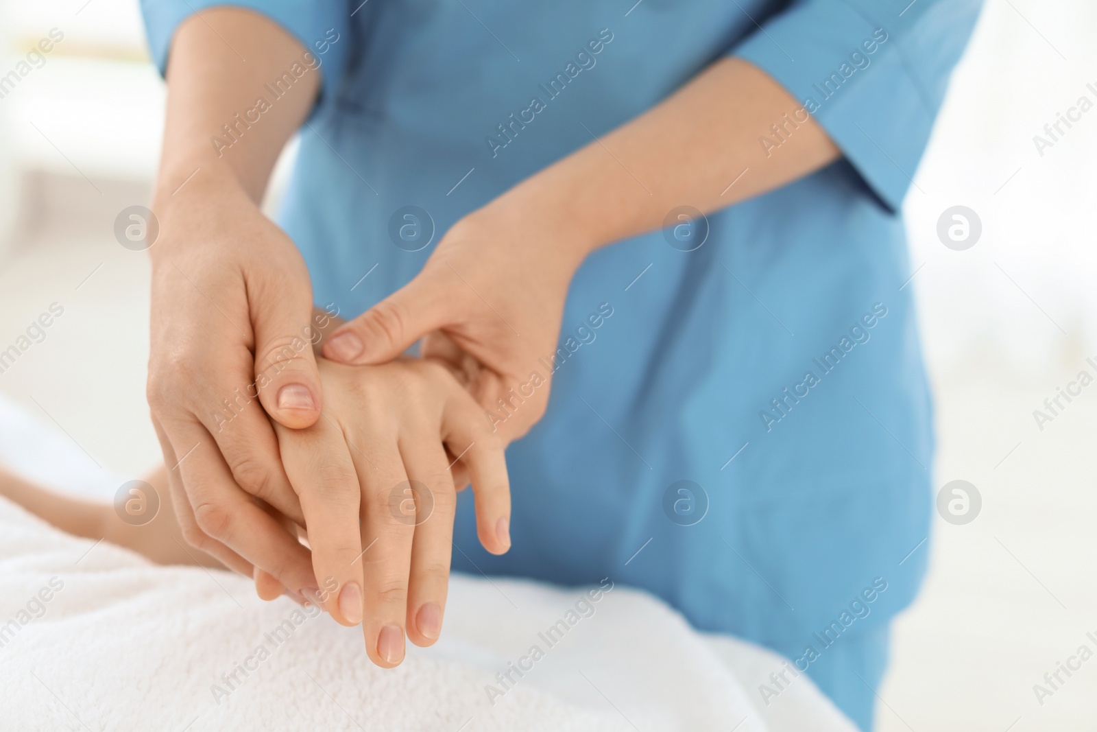 Photo of Woman receiving hand massage in wellness center, closeup