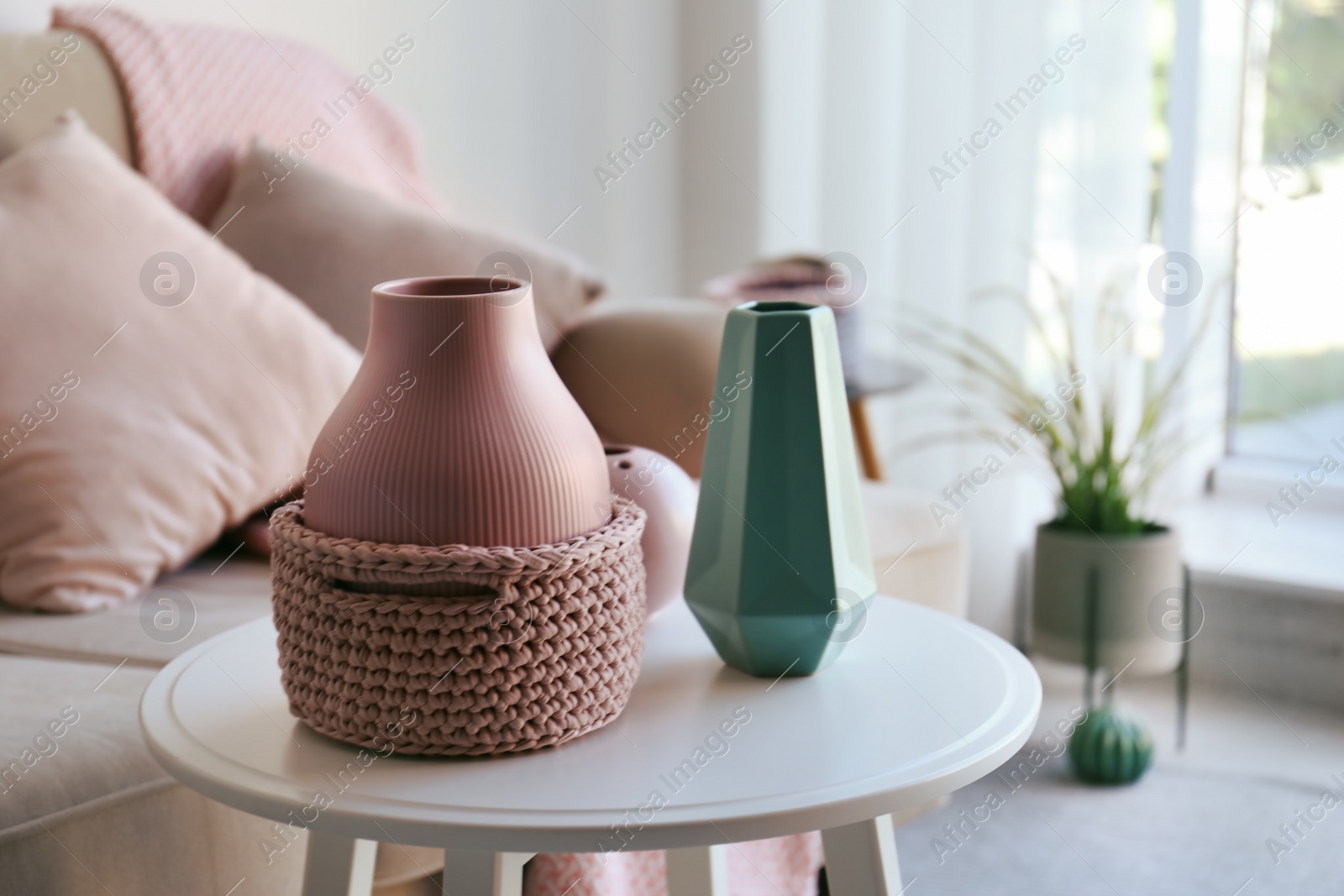 Photo of Side table with beautiful interior elements in living room