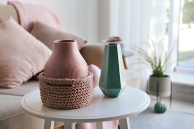 Photo of Side table with beautiful interior elements in living room