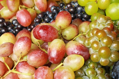 Fresh ripe juicy grapes with water drops as background, closeup