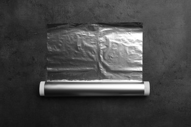 Photo of Roll of foil paper on grey table, top view