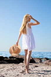 Photo of Young woman near sea on sunny day in summer