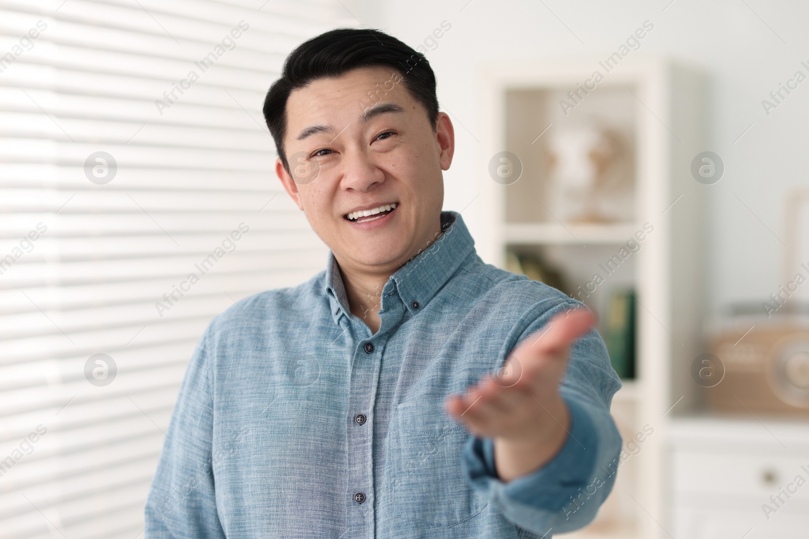 Photo of Portrait of smiling friendly businessman in office