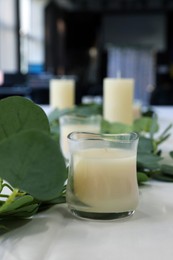 Photo of Beautiful table setting with eucalyptus branches and candles in restaurant