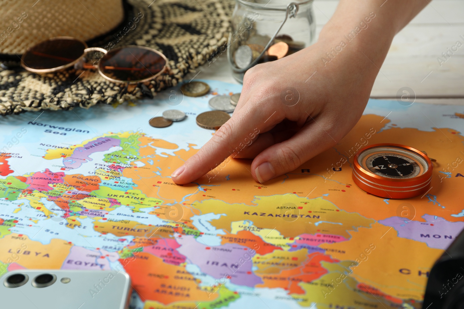 Photo of Woman with world map at table, closeup. Travel during summer vacation