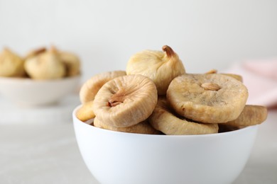 Photo of Tasty dried figs on light grey table, closeup