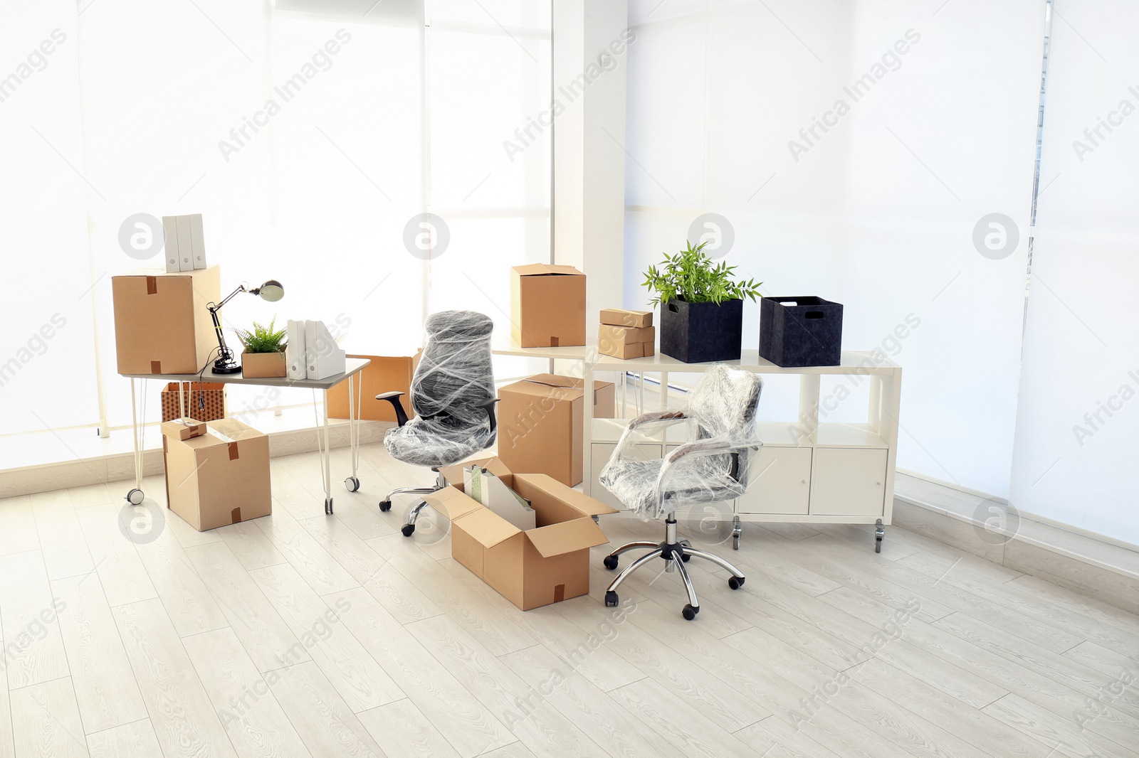 Photo of Moving boxes and furniture in new office