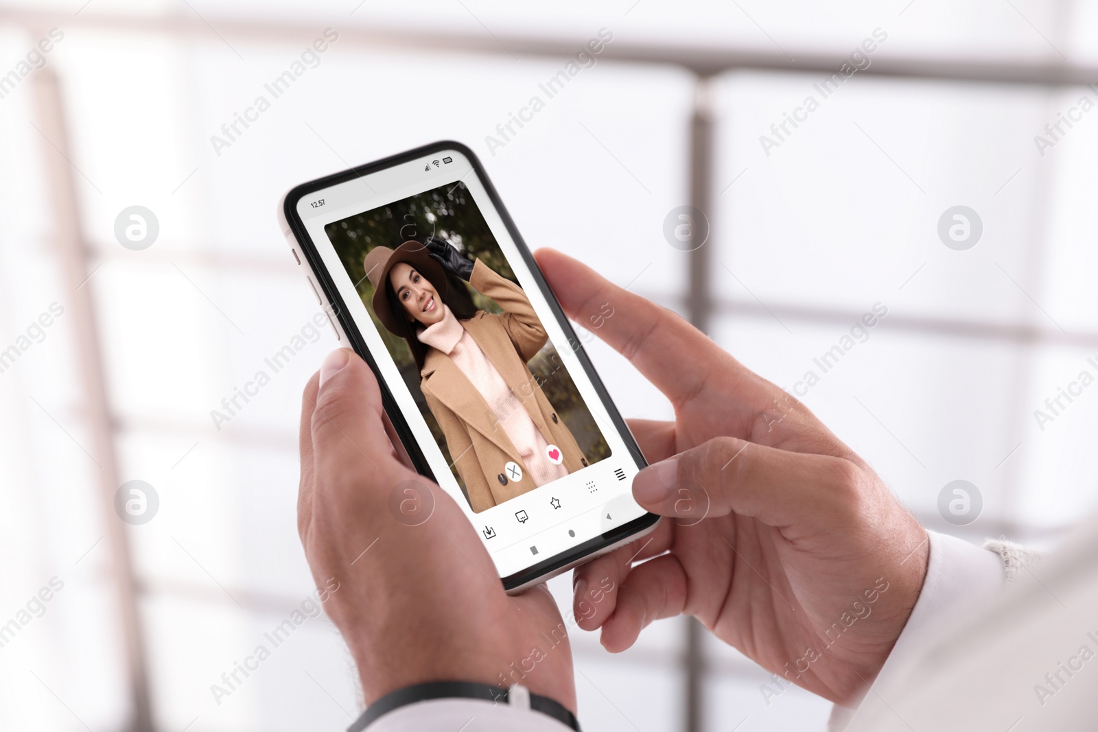 Image of Man visiting dating site via smartphone indoors, closeup