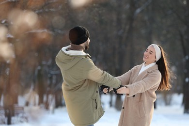 Photo of Beautiful young couple enjoying winter day outdoors