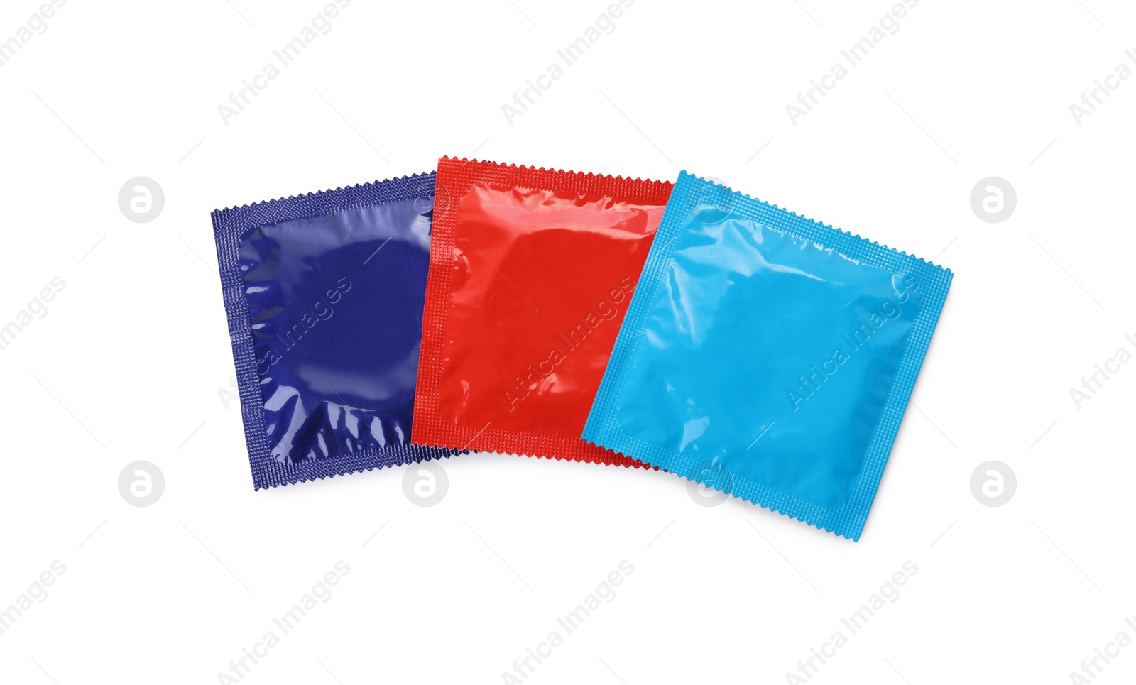 Photo of Packaged condoms on white background, top view. Safe sex