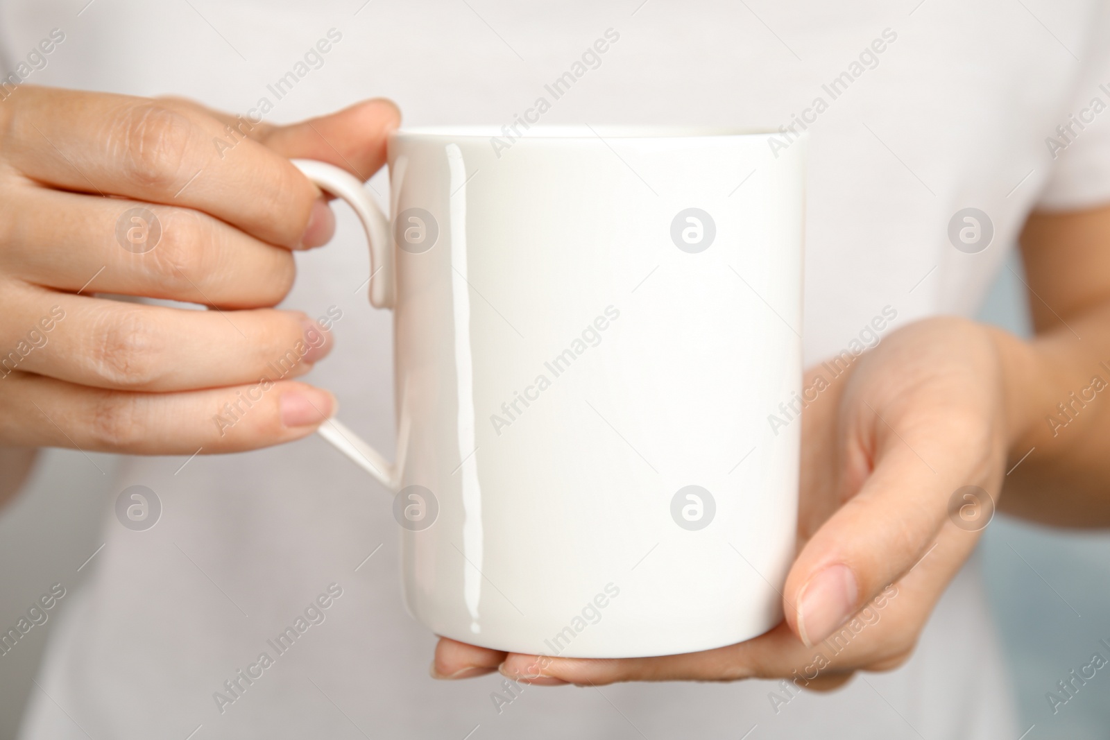 Photo of Woman holding ceramic cup, closeup. Mock up for design