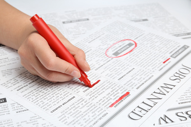 Photo of Woman marking advertisement in newspaper, closeup. Job search concept