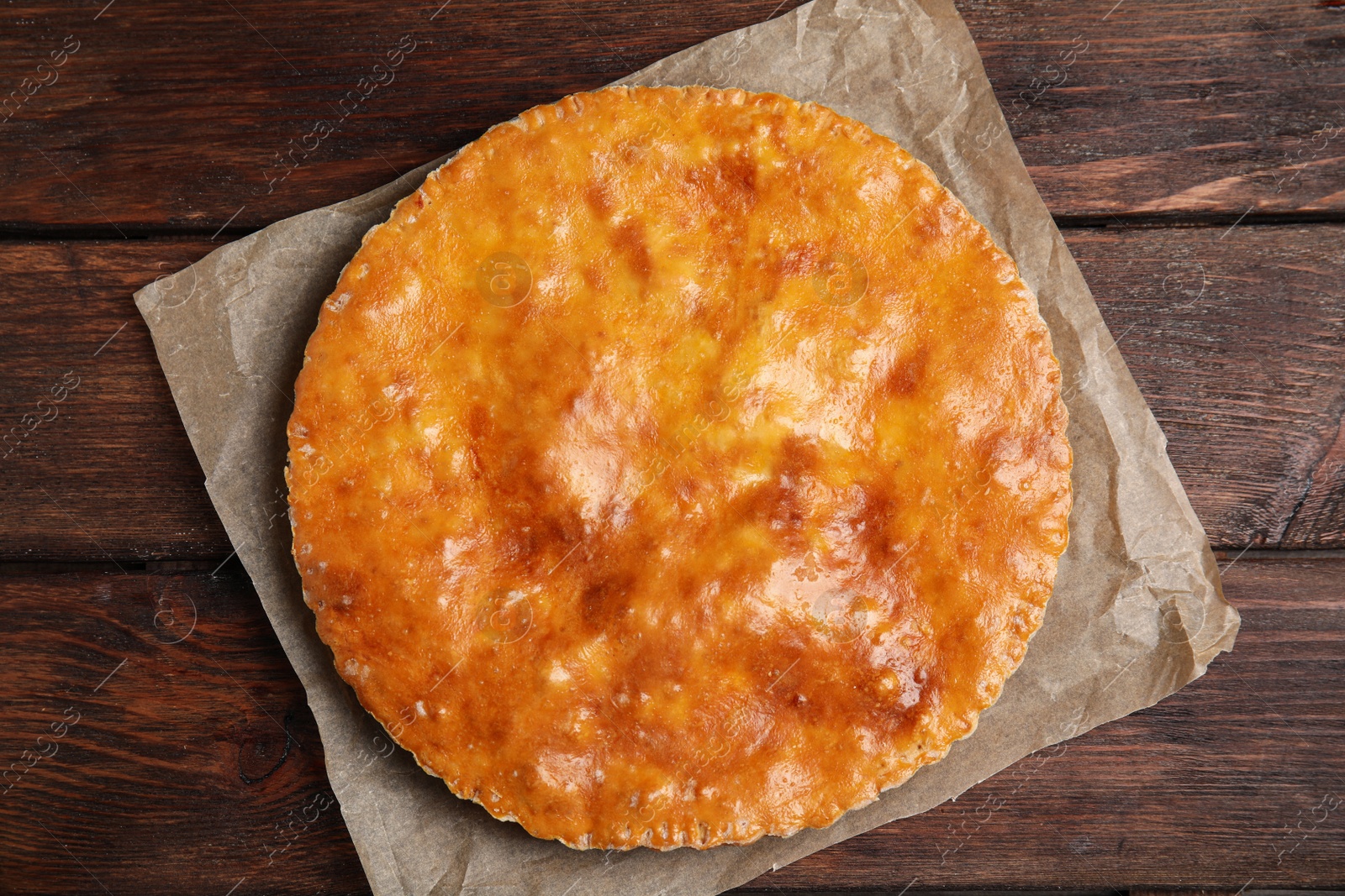 Photo of Delicious pie with meat on wooden table, top view