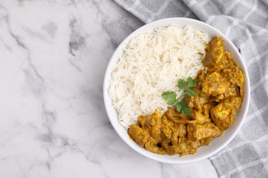 Photo of Delicious chicken curry with rice on white marble table, top view. Space for text