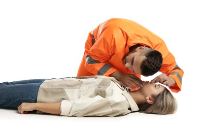Photo of Paramedic in uniform performing first aid on unconscious woman against white background