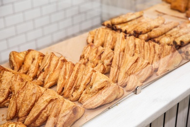 Fresh pastries on counter in bakery store. Space for text