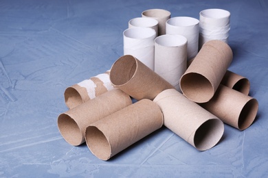 Empty toilet paper rolls on color background