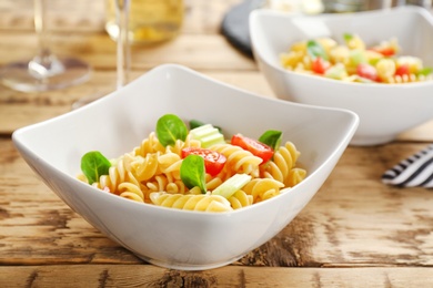 Photo of Bowls with delicious pasta primavera on table