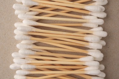 Photo of Many clean cotton buds on cardboard, flat lay