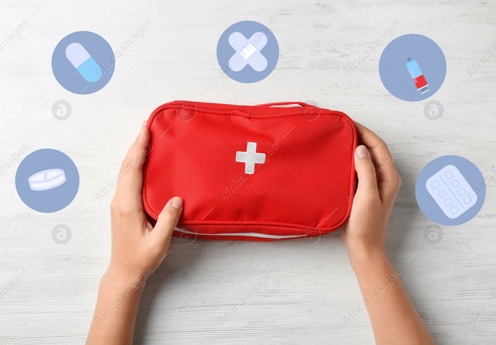 Image of Woman holding first aid kit on wooden background, top view