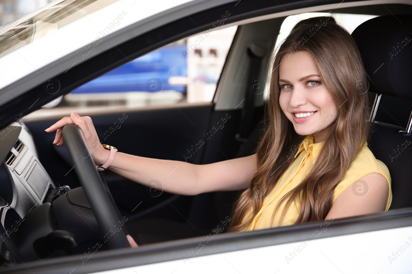 Photo of Young woman sitting on driver's seat of car