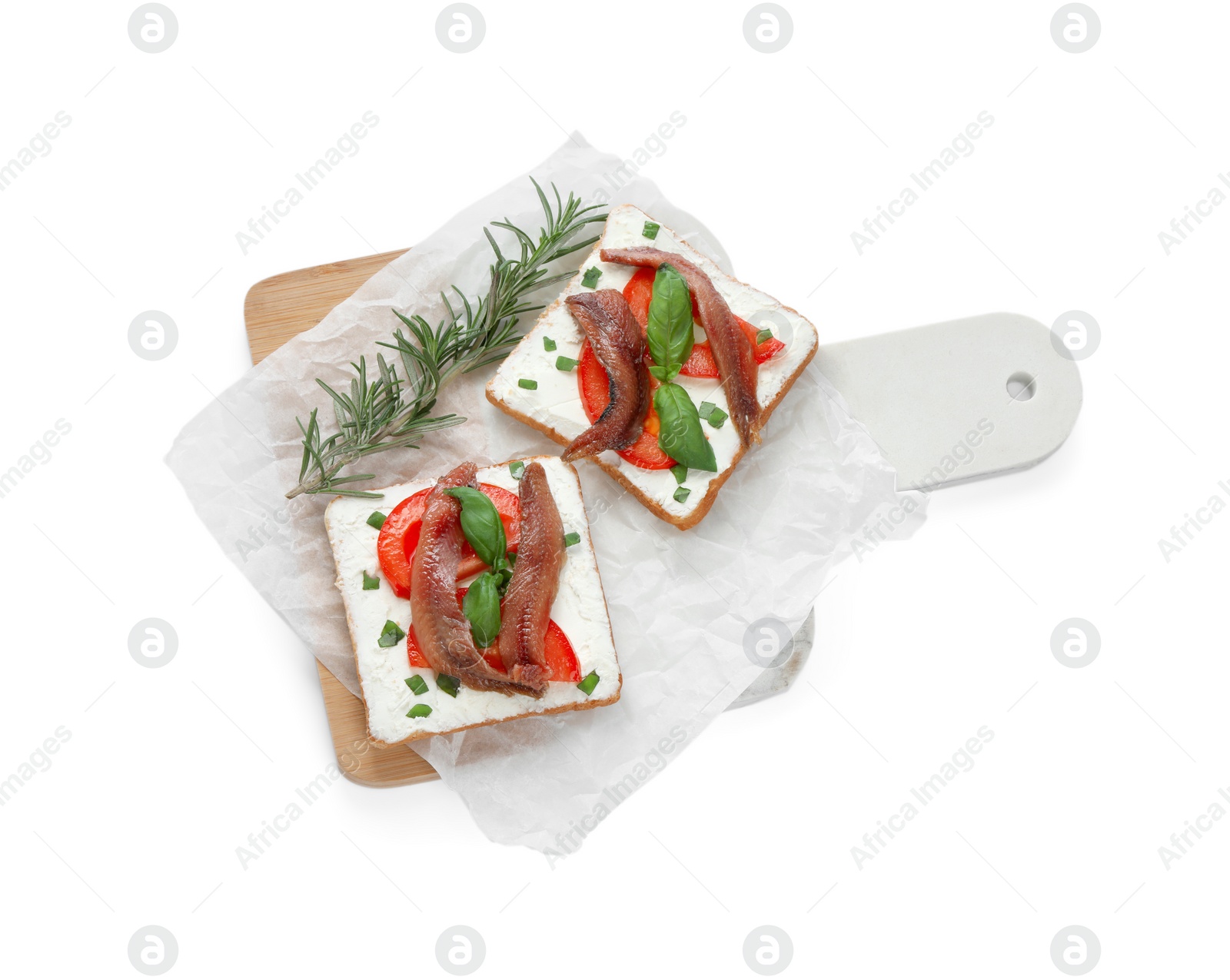 Photo of Delicious sandwiches with cream cheese, anchovies, tomatoes and basil on white background, top view