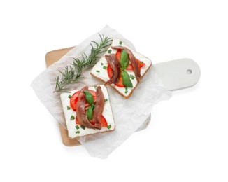 Photo of Delicious sandwiches with cream cheese, anchovies, tomatoes and basil on white background, top view