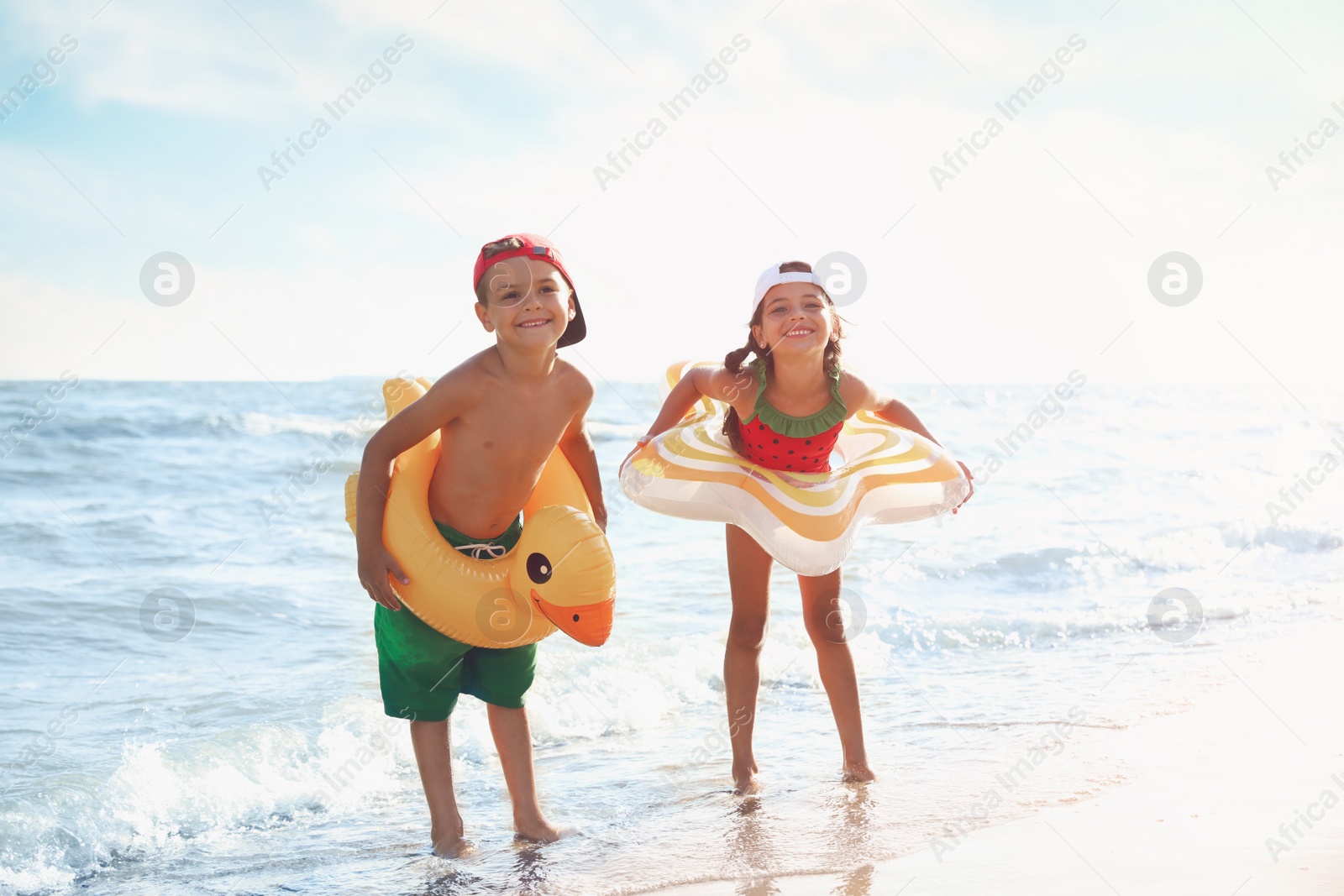 Photo of Cute children enjoying sunny day at beach. Summer camp