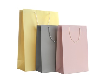 Photo of Different paper shopping bags isolated on white