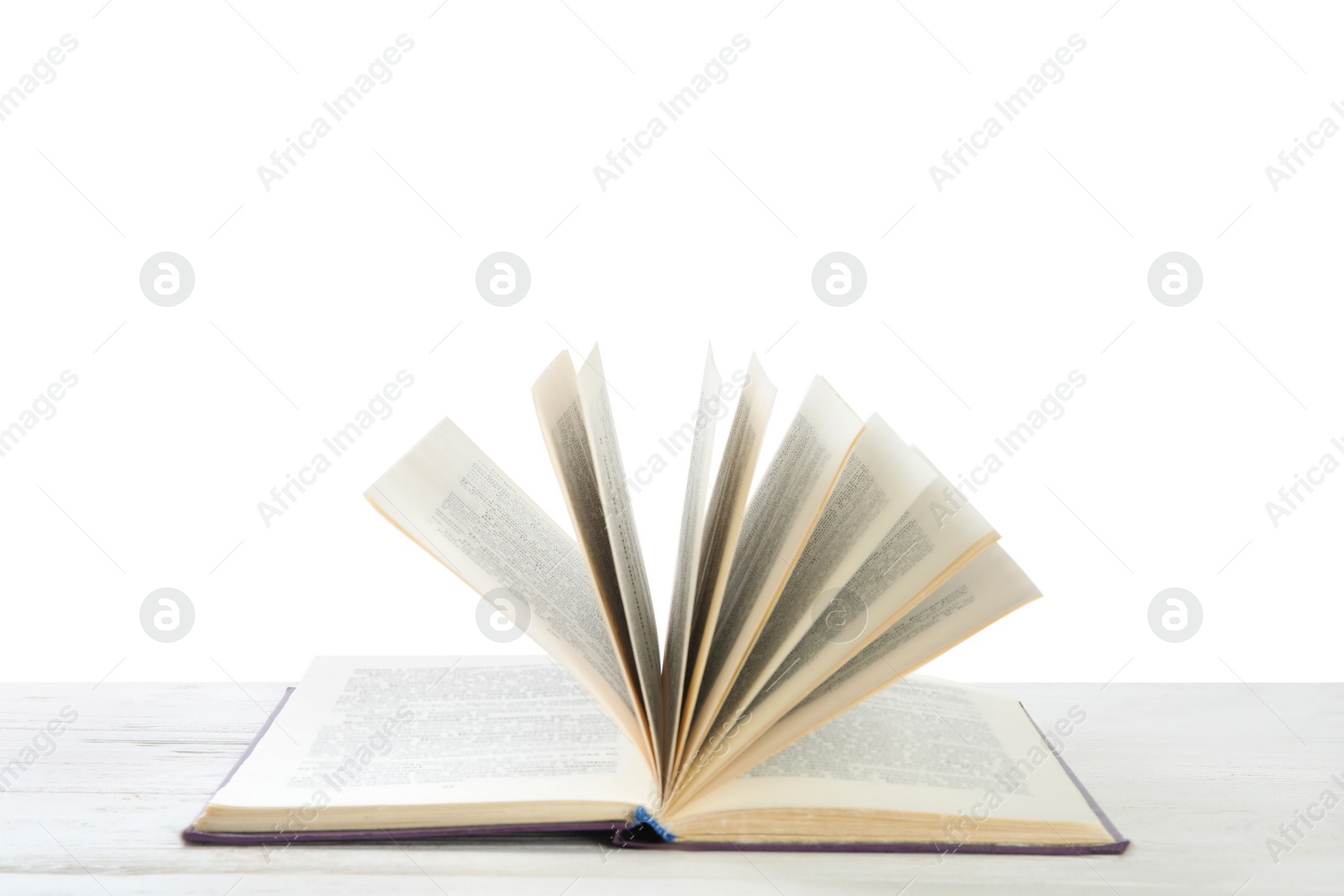 Photo of Open old hardcover book on wooden table