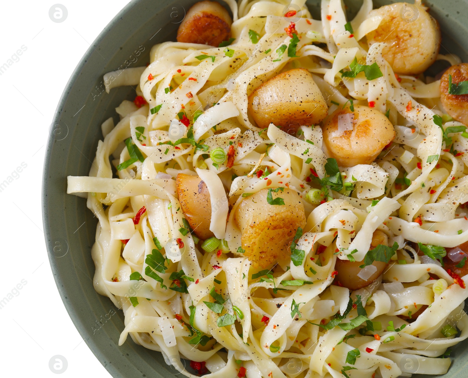 Photo of Delicious scallop pasta with spices in bowl on white table, top view