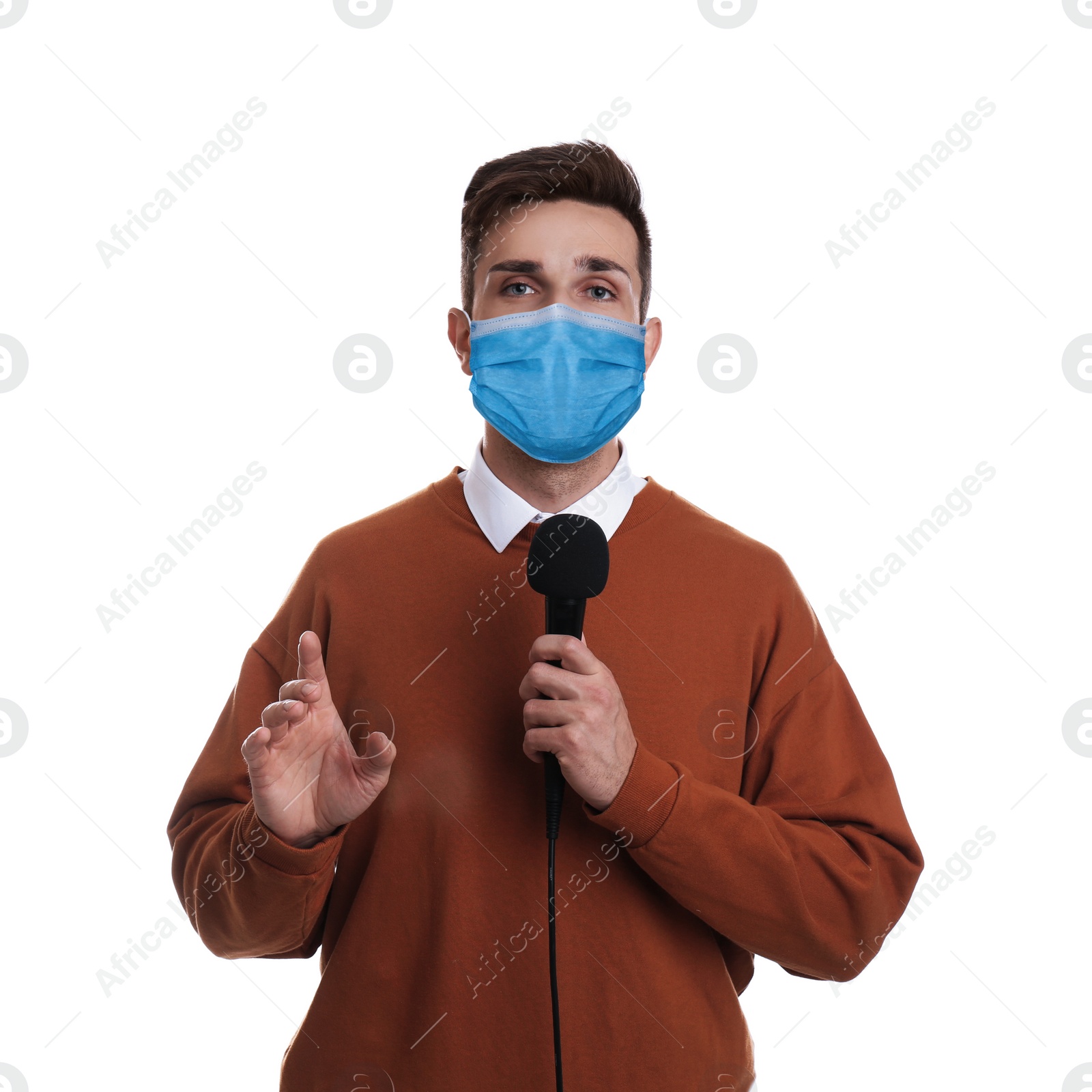 Image of Young journalist with microphone wearing medical mask on white background. Virus protection